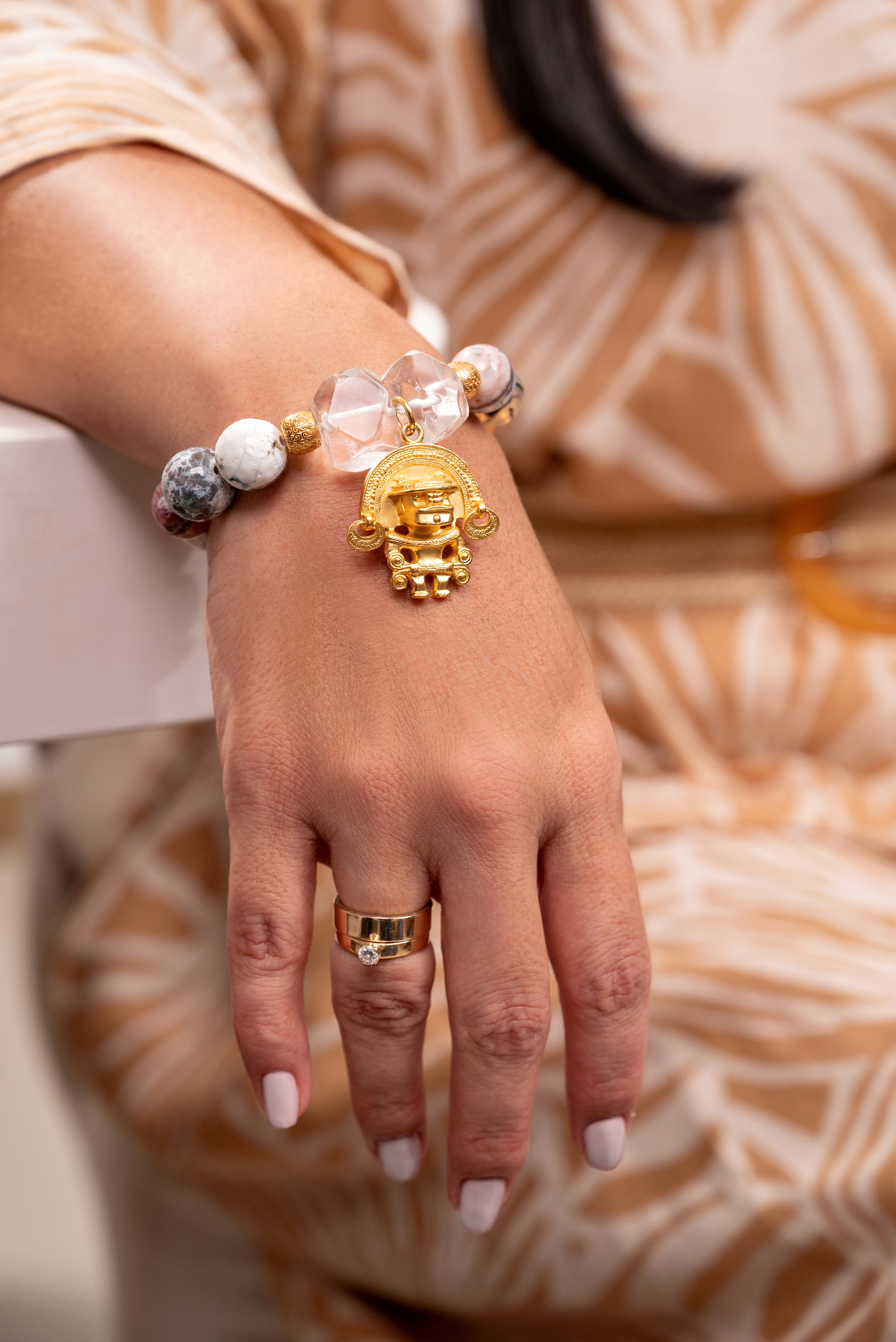 Woman wearing gemstone Jewellery with 24K gold plated charms 